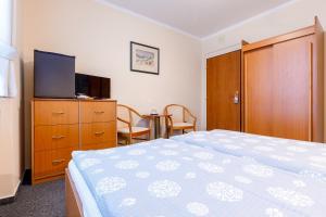 Postel nebo postele na pokoji v ubytování Hotel Jitřenka