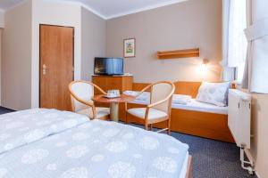 Postel nebo postele na pokoji v ubytování Hotel Jitřenka
