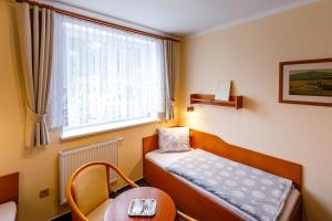 Postel nebo postele na pokoji v ubytování Hotel Jitřenka