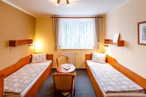 Postel nebo postele na pokoji v ubytování Hotel Jitřenka