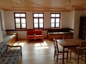 a living room with a couch and a table and chairs at Kastro View in Limenaria