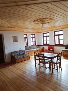 a living room with a table and chairs and a couch at Kastro View in Limenaria