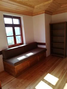 a living room with a couch and a window at Kastro View in Limenaria