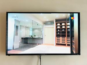 a flat screen tv hanging on a wall at Homestay Cahaya 1 Seri Iskandar in Seri Iskandar