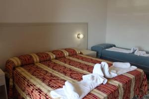 Łóżko lub łóżka w pokoju w obiekcie Hotel Al Bosco