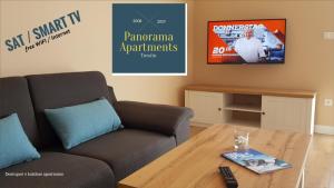 Televízia a/alebo spoločenská miestnosť v ubytovaní Panorama Apartmens Trenčín