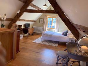 a bedroom with a bed and a table and chairs at Demesne Farm Guesthouse in Monmouth