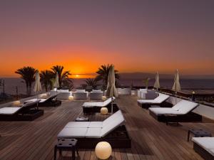 a resort patio with white couches and the sunset at H10 Gran Tinerfe - Adults Only in Adeje
