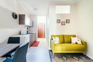 a living room with a yellow couch in a kitchen at La Corte dei Balconi 1 in Como