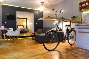 a bike parked in a kitchen and a living room at Walk Inn Váci 78 in Budapest