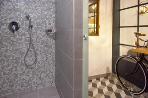 a bathroom with a shower with a bike in it at Walk Inn Váci 78 in Budapest