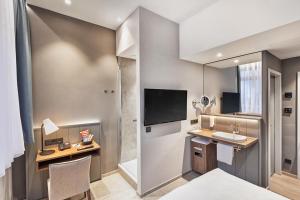 a kitchen with a refrigerator and a sink at H+ Hotel Bremen in Bremen
