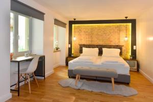 a bedroom with a bed and a table and a desk at Walk Inn Váci 78 in Budapest