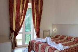 Postel nebo postele na pokoji v ubytování Hotel Al Bosco + 37 fotografií