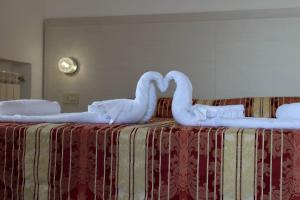 Łóżko lub łóżka w pokoju w obiekcie Hotel Al Bosco