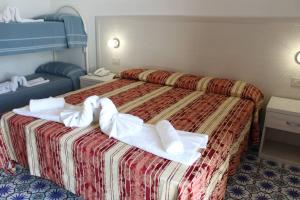 Łóżko lub łóżka w pokoju w obiekcie Hotel Al Bosco