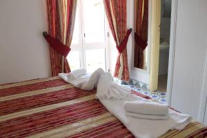 Łóżko lub łóżka w pokoju w obiekcie Hotel Al Bosco