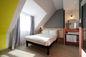 Säng eller sängar i ett rum på ibis Styles Wien Messe Prater