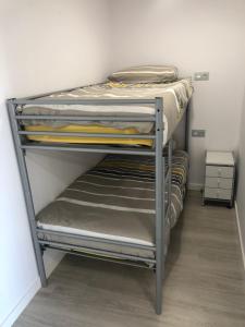 a bunk bed in a room with a closet at La Moderna Apartament in Salou