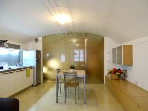 a kitchen with a table and chairs in a room at Cavour 96 in Mantova