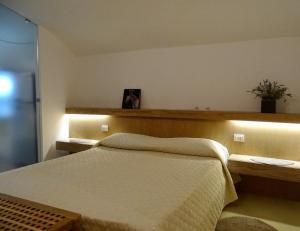 a bedroom with a bed and a wooden headboard at Cavour 96 in Mantova