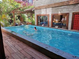a person swimming in a large swimming pool at Hotel Middle Path & Spa in Pokhara