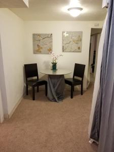 a dining room with a table and two chairs at Southern Hospitality House in Lakewood