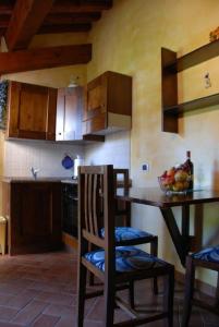 a kitchen with a table and chairs and a counter at B&B Pergolato di Sotto in San Casciano in Val di Pesa