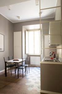a kitchen and dining room with a table and chairs at Four Elements in Rome +33 photos