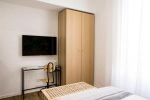 a bedroom with a bed and a cabinet with a tv at Four Elements in Rome