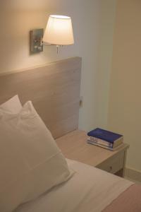 
A bed or beds in a room at Alkyon Beach Hotel
