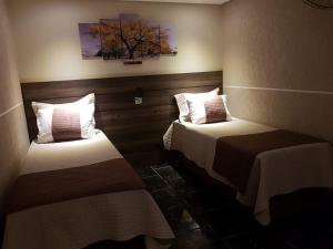 Uma cama ou camas num quarto em Hotel Contorno Sul