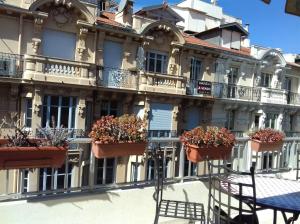 a building with potted plants on the side of it at Appartamento Sole in Nice