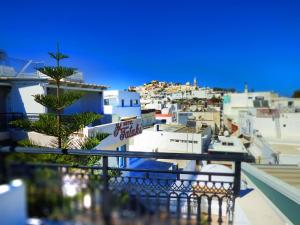a view of a city from a balcony at Tataki Hotel in Fira