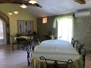 a dining room with a large table and chairs at La Minaudière in Nueil-sous-les-Aubiers