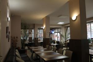 a row of tables and chairs in a restaurant at Family Hotel Bulgaria in Kharmanli