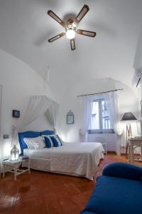 a bedroom with a bed with a ceiling fan at Vicolo 23 House in Atrani