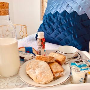a plate of bread and milk on a table at Apartments Alfacinha Ajuda in Lisbon