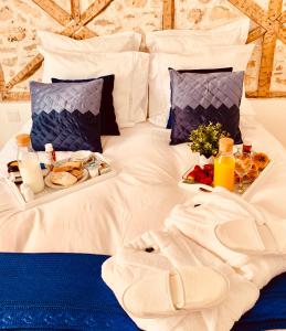 a white bed with a tray of food on it at Apartments Alfacinha Ajuda in Lisbon