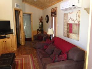 a living room with a couch and a tv at Pine Mountain RV Resort in Pine Mountain