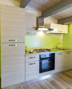 a kitchen with white cabinets and a stove top oven at Il Sopracciglio Suites - Green Suite in Cassino