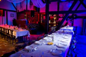 a long table in a room with purple lighting at Kietlice nad Mamrami in Węgorzewo