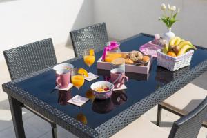 a blue table with a tray of fruit and juice at Apartments Braut Krk in Krk
