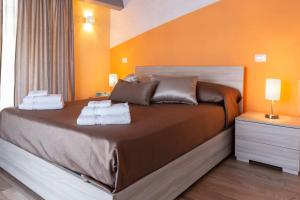 A bed or beds in a room at Il Sopracciglio Suites - Red Suite