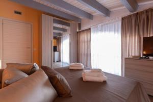 A bed or beds in a room at Il Sopracciglio Suites - Red Suite