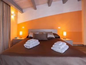 A bed or beds in a room at Il Sopracciglio Suites - Red Suite