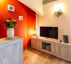 A television and/or entertainment centre at Il Sopracciglio Suites - Red Suite