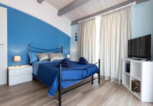 A television and/or entertainment centre at Il Sopracciglio Suites - Red Suite
