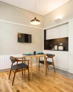 a kitchen and dining room with a table and chairs at Porto Republica Apartments in Porto