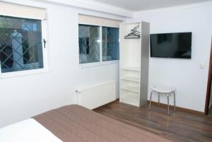 TV a/nebo společenská místnost v ubytování Hotel Elisa Cole